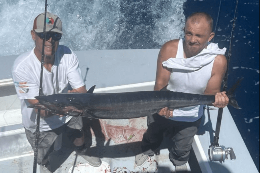 Client holding a Wahoo Offshore on a fishing Charter